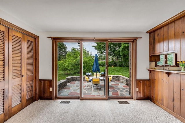 169 Mountainview Rd, East Longmeadow, MA 01028 - doorway to outside featuring a wainscoted wall, wooden walls, and carpet flooring