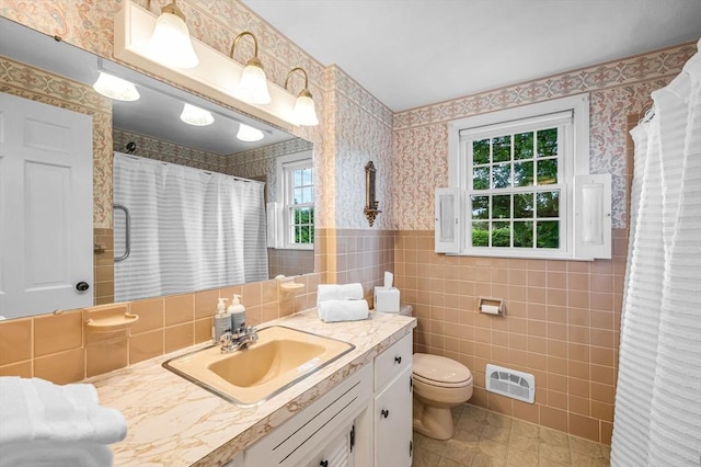 169 Mountainview Rd, East Longmeadow, MA 01028 - bathroom with wallpapered walls, plenty of natural light, vanity, toilet, and tile walls