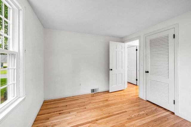 169 Mountainview Rd, East Longmeadow, MA 01028 - unfurnished bedroom featuring light wood finished floors, multiple windows, and baseboards