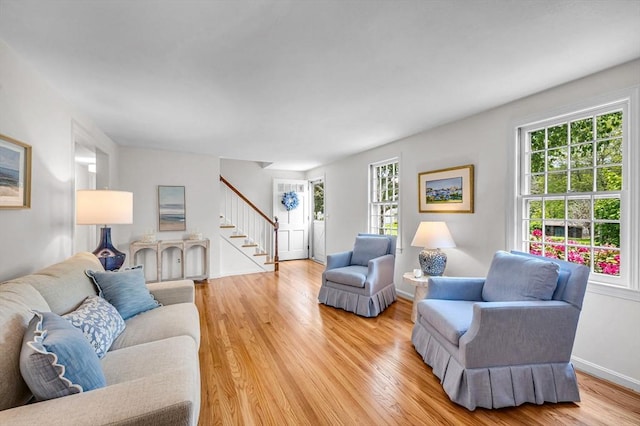 169 Mountainview Rd, East Longmeadow, MA 01028 - living room with stairway, plenty of natural light, light wood-style flooring, and baseboards