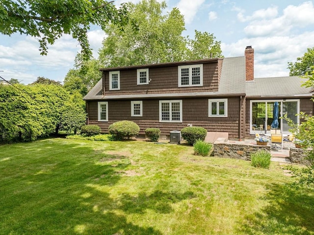 169 Mountainview Rd, East Longmeadow, MA 01028 - rear view of house featuring a patio, a chimney, a yard, and central AC unit