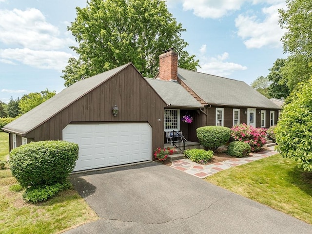169 Mountainview Rd, East Longmeadow, MA 01028 - view of front of home featuring an attached garage, a chimney, asphalt driveway, and a front lawn