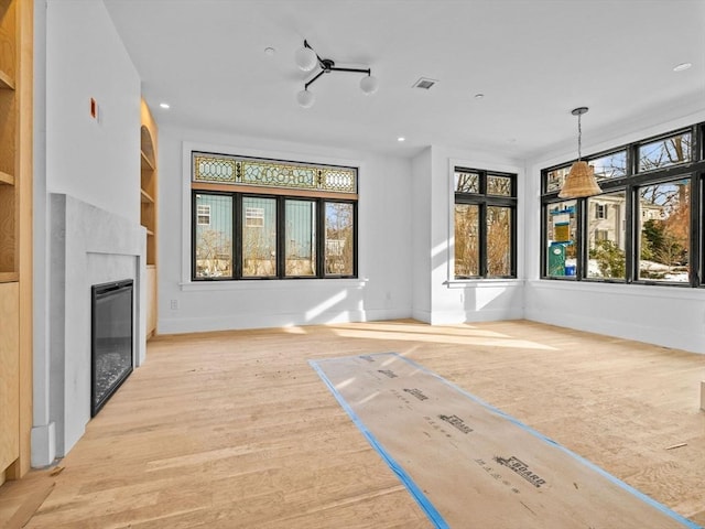 unfurnished living room featuring light wood-type flooring