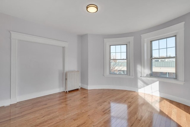 interior space with radiator heating unit and light wood-type flooring