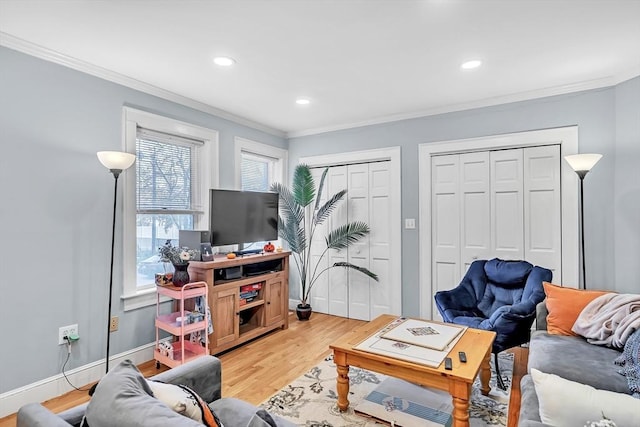 living room with crown molding and hardwood / wood-style floors