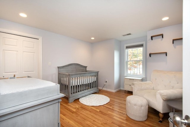 bedroom with light wood-type flooring, visible vents, baseboards, and recessed lighting