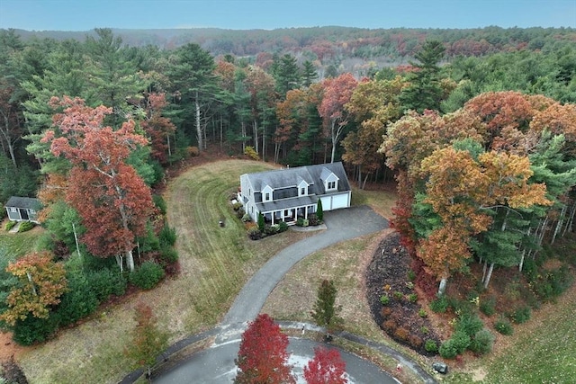 drone / aerial view featuring a wooded view