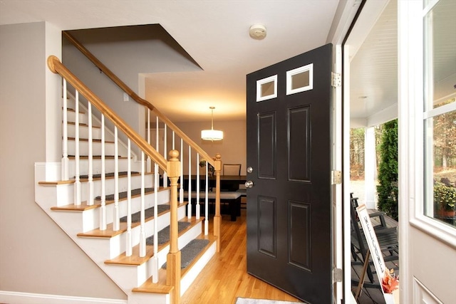 entryway with light wood-type flooring and stairs