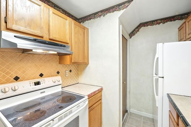 124 College St Unit 20, South Hadley, MA 01075 - kitchen with white appliances, under cabinet range hood, backsplash, and tile countertops