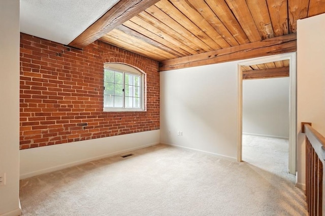 124 College St Unit 20, South Hadley, MA 01075 - carpeted empty room with wooden ceiling, baseboards, and brick wall