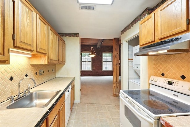 124 College St Unit 20, South Hadley, MA 01075 - kitchen featuring white appliances, under cabinet range hood, tile countertops, and stacked washing machine and dryer