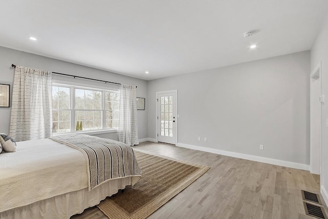 bedroom featuring light wood-type flooring and multiple windows