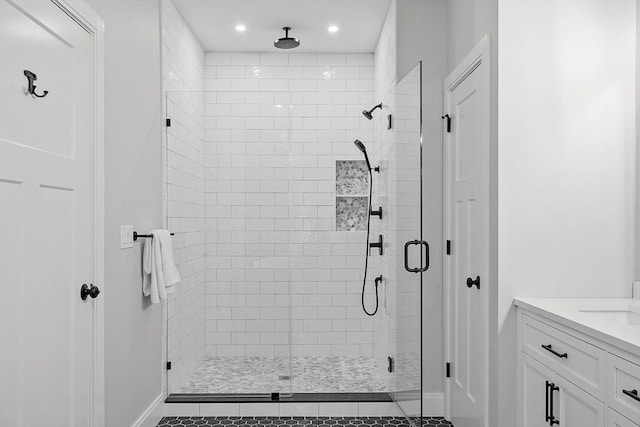 bathroom featuring tile patterned floors, vanity, and a shower with door