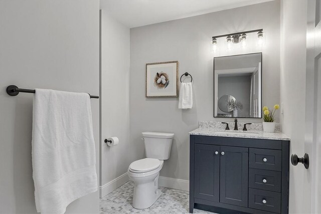 bathroom featuring tile patterned flooring, vanity, and toilet