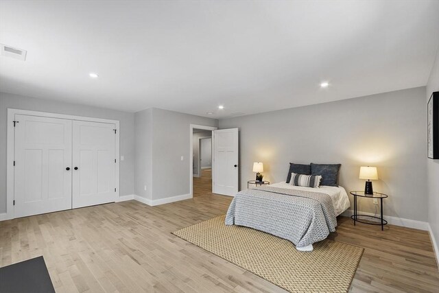 bedroom featuring light wood-type flooring and a closet