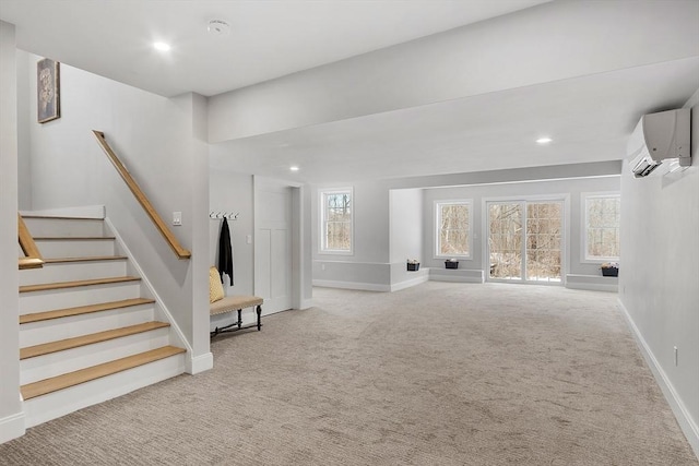 interior space with a wall mounted air conditioner and light carpet