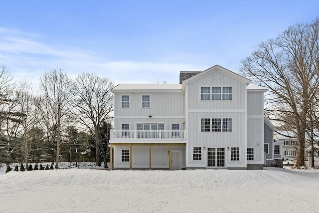 view of snow covered back of property