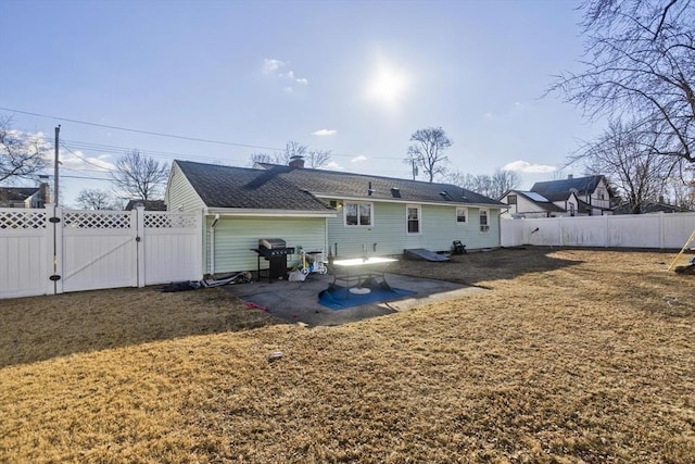 rear view of property with a patio area and a yard