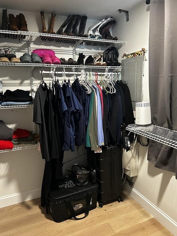 walk in closet featuring wood finished floors