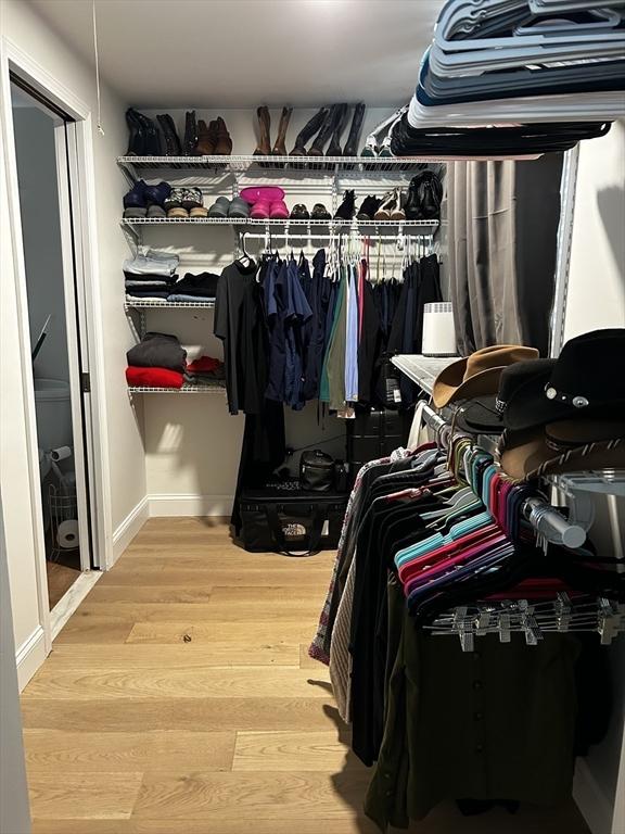 spacious closet featuring wood finished floors