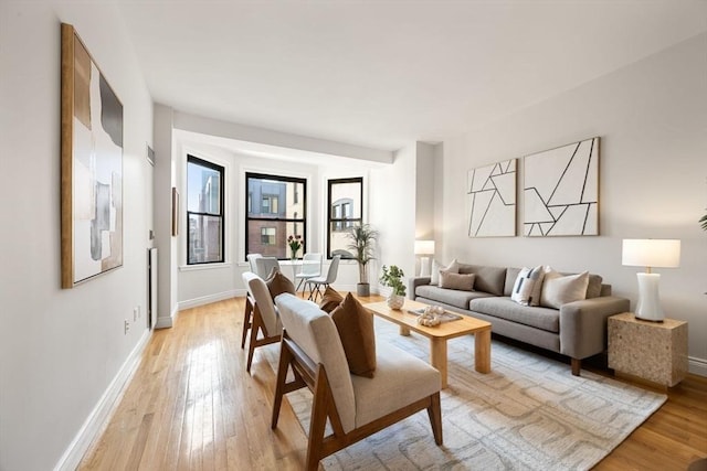 living area featuring light wood-type flooring and baseboards