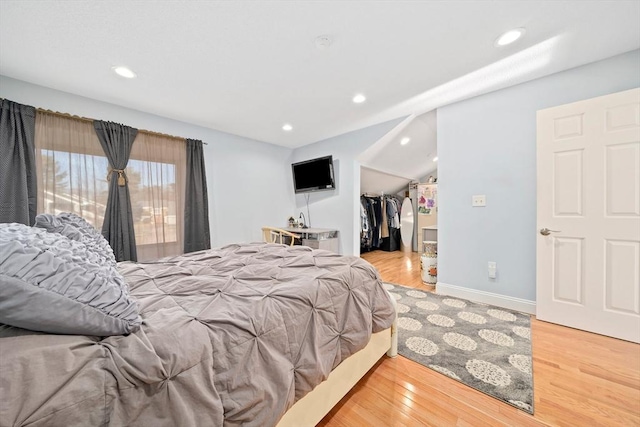 bedroom featuring wood-type flooring, a closet, and a walk in closet