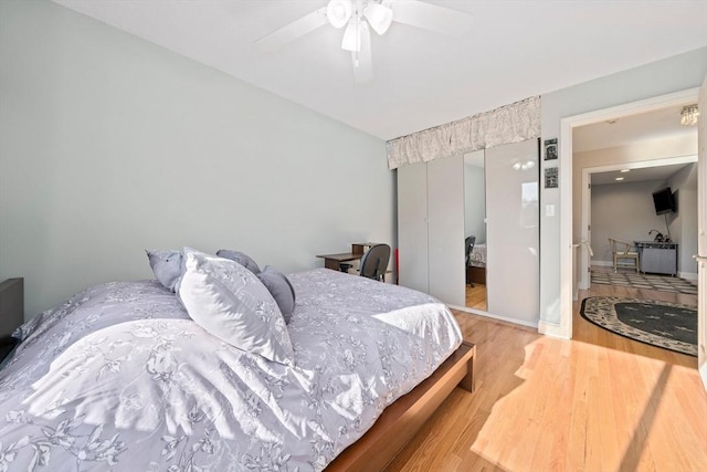 bedroom with ceiling fan and hardwood / wood-style flooring