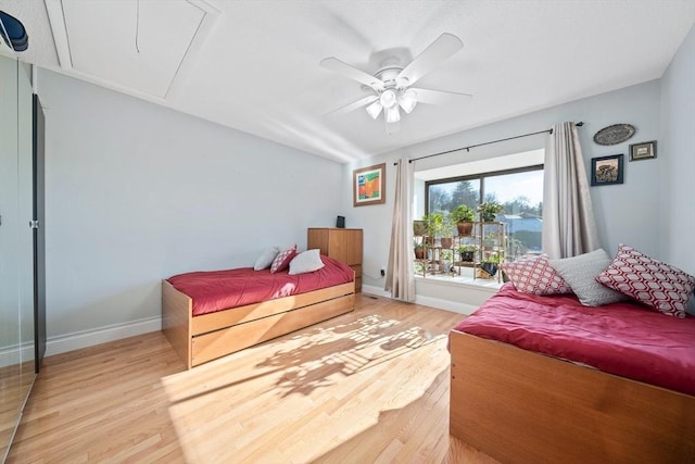 bedroom with ceiling fan and light hardwood / wood-style floors