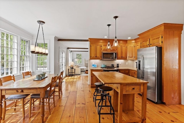 6 Shannon Cir, Westford, MA 01886 - kitchen featuring appliances with stainless steel finishes, wood counters, light wood-style flooring, ornamental molding, and pendant lighting