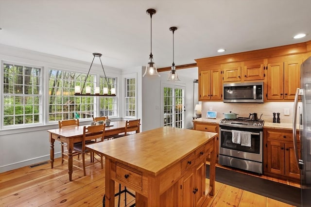 6 Shannon Cir, Westford, MA 01886 - kitchen with stainless steel appliances, healthy amount of natural light, butcher block countertops, tasteful backsplash, and recessed lighting