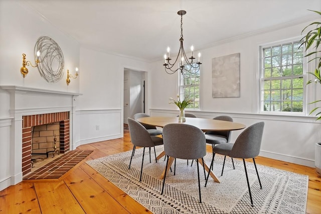 6 Shannon Cir, Westford, MA 01886 - dining area with a chandelier, light wood finished floors, crown molding, and a brick fireplace
