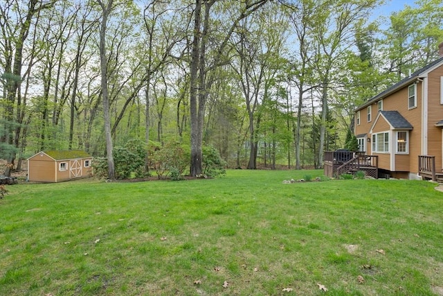 6 Shannon Cir, Westford, MA 01886 - view of grassy yard with a storage unit, a deck, and an outbuilding