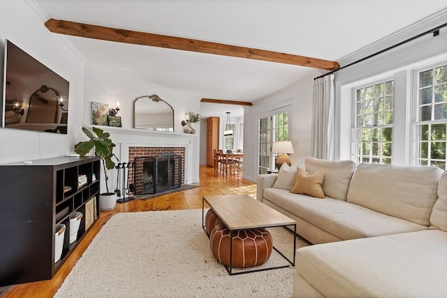 6 Shannon Cir, Westford, MA 01886 - living area featuring beamed ceiling, light wood-style flooring, and a brick fireplace
