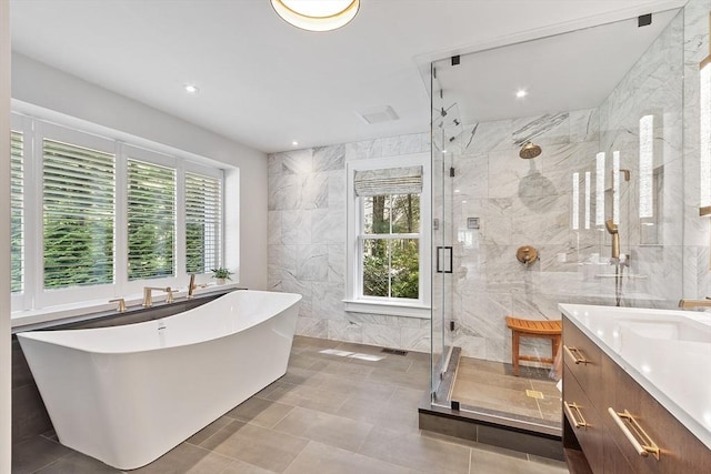 31 Alford Cir, Concord, MA 01742 - bathroom featuring tile walls, plenty of natural light, vanity, a shower stall, and a soaking tub