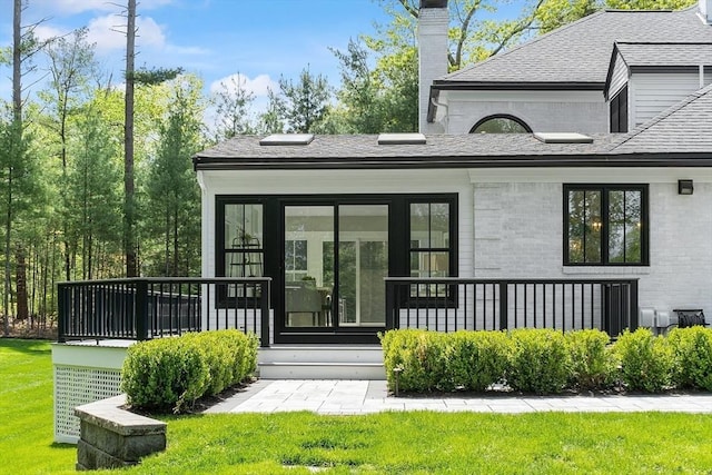 31 Alford Cir, Concord, MA 01742 - doorway to property with a chimney, a yard, a shingled roof, and brick siding