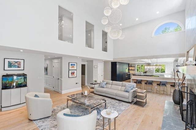 31 Alford Cir, Concord, MA 01742 - living area featuring a chandelier, light wood-style flooring, a high ceiling, and recessed lighting