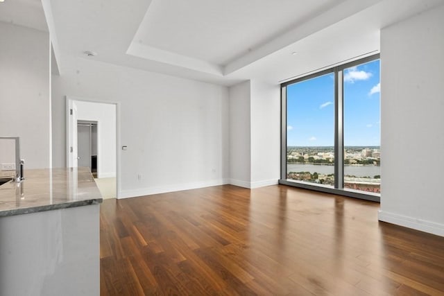 1 Dalton St Unit 3302, Boston, MA 02199 - unfurnished living room with dark wood-style flooring, floor to ceiling windows, baseboards, and a raised ceiling
