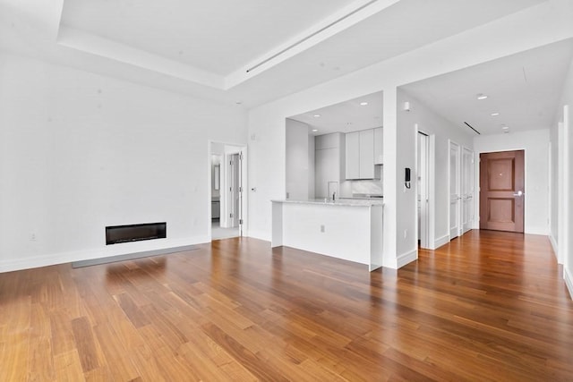 1 Dalton St Unit 3302, Boston, MA 02199 - unfurnished living room featuring wood finished floors, a glass covered fireplace, and baseboards