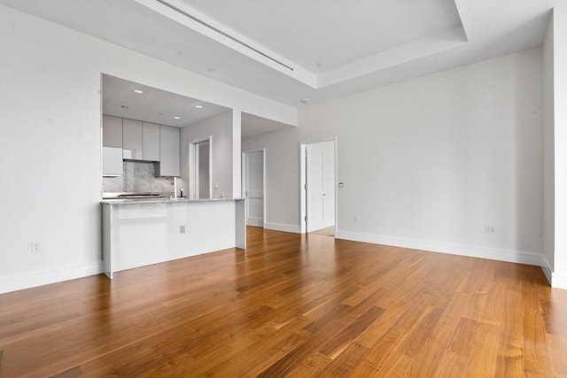 1 Dalton St Unit 3302, Boston, MA 02199 - unfurnished living room with light wood-style floors, a tray ceiling, baseboards, and recessed lighting
