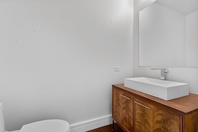 1 Dalton St Unit 3302, Boston, MA 02199 - half bathroom with toilet, vanity, baseboards, and wood finished floors