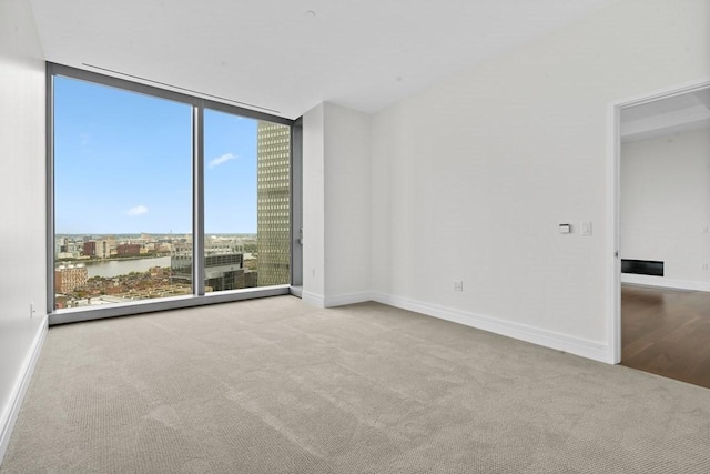 1 Dalton St Unit 3302, Boston, MA 02199 - carpeted empty room with floor to ceiling windows, baseboards, and a water view