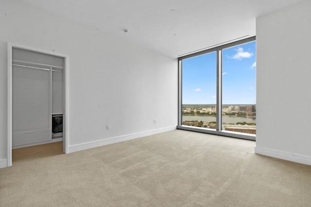 1 Dalton St Unit 3302, Boston, MA 02199 - carpeted empty room with floor to ceiling windows, baseboards, and a water view