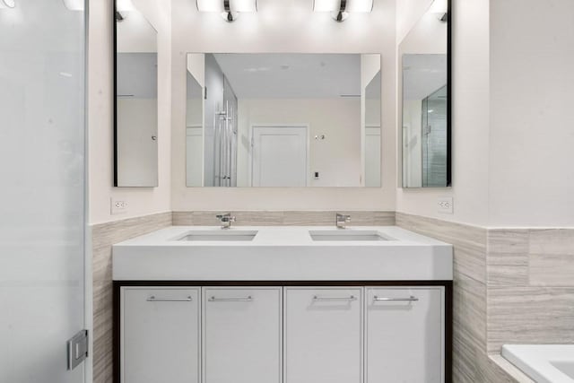 1 Dalton St Unit 3302, Boston, MA 02199 - full bath featuring tile walls, double vanity, a bath, and a wainscoted wall
