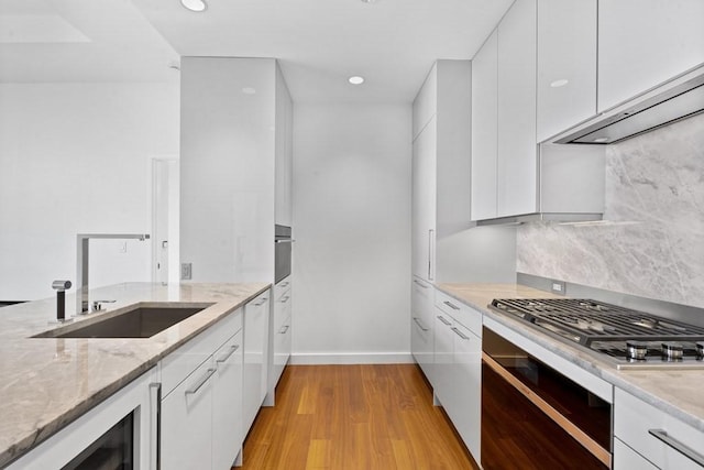 1 Dalton St Unit 3302, Boston, MA 02199 - kitchen with a sink, modern cabinets, beverage cooler, light stone countertops, and wall oven