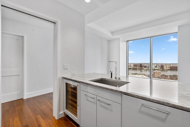 1 Dalton St Unit 3302, Boston, MA 02199 - kitchen featuring wine cooler, light stone countertops, white cabinetry, and dark wood-style flooring