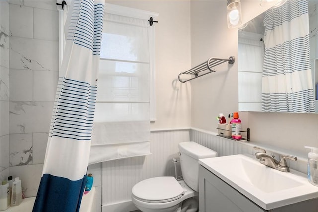 14 Forest Ave, Salem, MA 01970 - bathroom with a wainscoted wall, shower / bath combo with shower curtain, vanity, and toilet