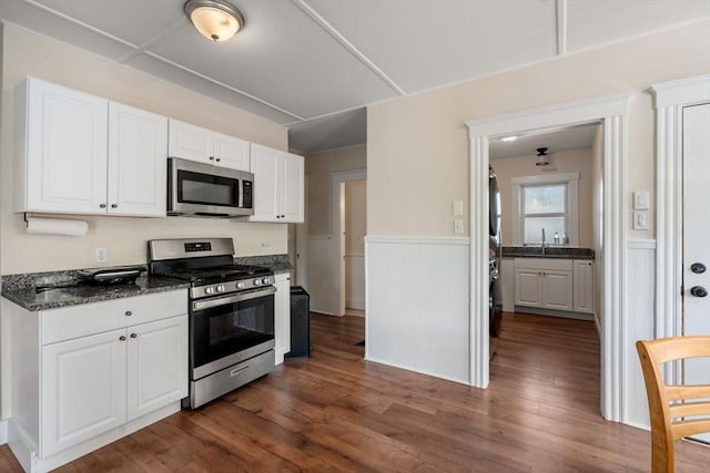 14 Forest Ave, Salem, MA 01970 - kitchen featuring stainless steel appliances, white cabinets, dark wood finished floors, a wainscoted wall, and a sink