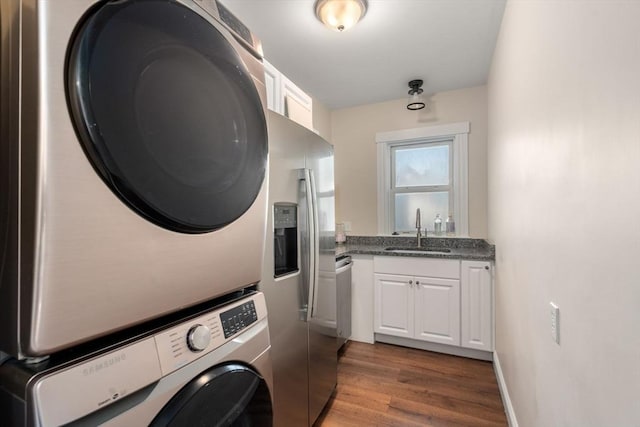 14 Forest Ave, Salem, MA 01970 - laundry area with estacked washer and dryer, dark wood finished floors, and bar with sink