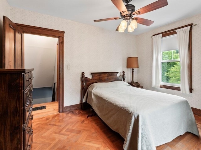bedroom featuring baseboards, ceiling fan, and visible vents