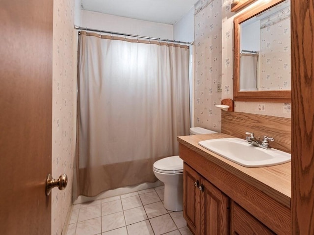 bathroom featuring vanity, toilet, wallpapered walls, and tile patterned flooring